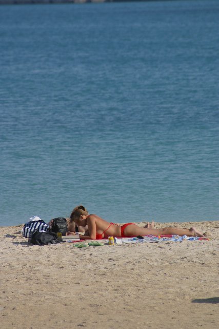 Relaxing on Ramla bay beach  in the sun 